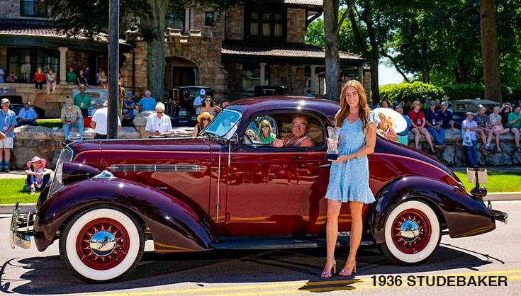 A 1936 Studebaker Dictator being presented Commanders and Dictators Award at the 2022 Copshaholm Concours d'Elegance. 