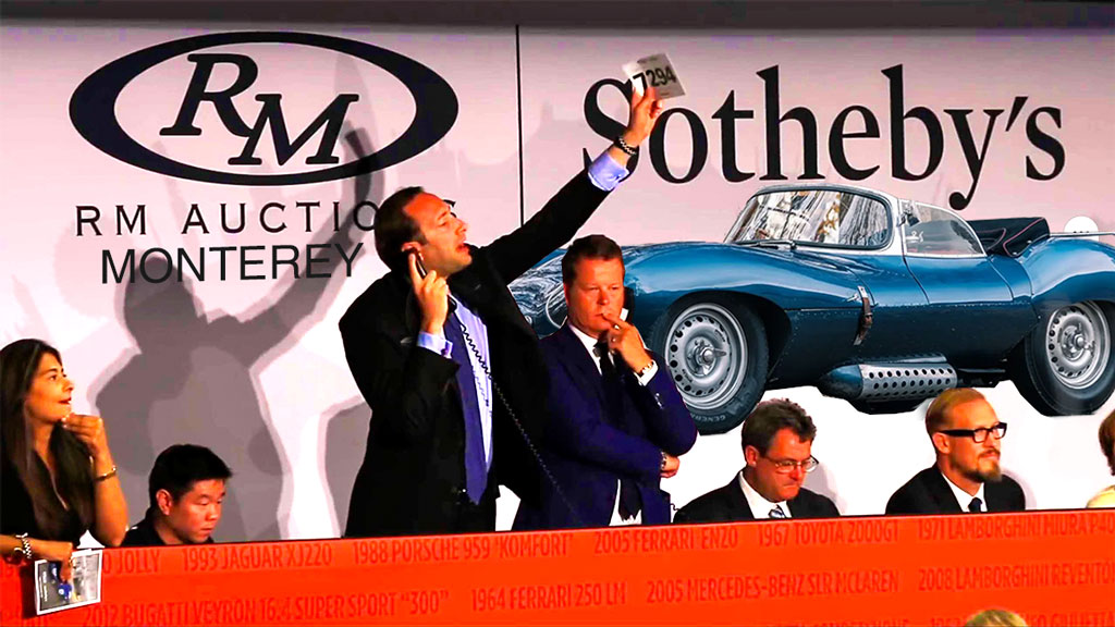 RM Sotheby’s Pebble Beach Auction Auctioneer Selling an Expensive Car