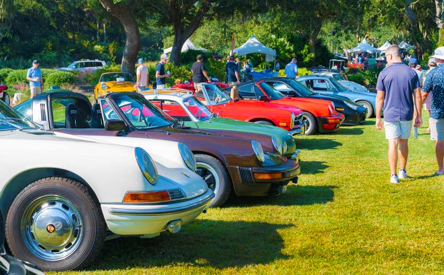 Collector vehicles lined up on the grass of the car show
