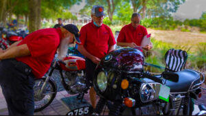 Judges looking at motorcycle at the Riding into History Motorcycle Concours d'Elegance