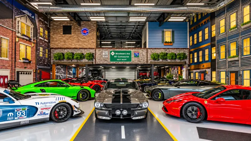 Customized private car condo garage at M1 Concourse with collector vehicles and trackside views