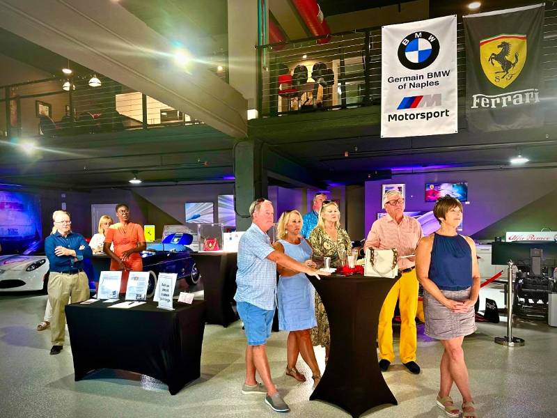 Excitement filled the air at Naples Ultimate Garages as car enthusiasts gathered for a high-energy fundraiser