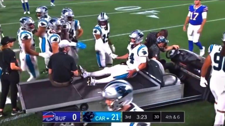 Sam Darnold in a golf cart after injury