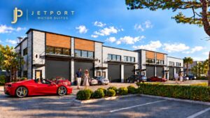 Jetport Motor Suites Car Club Entrance with a Ferrari sports car pulling into the car condo community