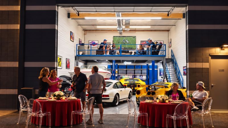 Motor-Vault garage suite in Arizona, shown in a social setting with owners and guests gathered around collector cars.